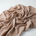 Interlock (Stretch) Wholesale Fabric in Taupe/D 1184 - loose-fold fabric view