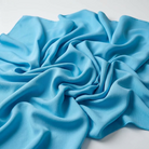 Interlock (Stretch) Wholesale Fabric in Turquoise 1141 - loose-fold fabric view