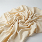 Interlock (Stretch) Wholesale Fabric in Vanilla 1111 - loose-fold fabric view