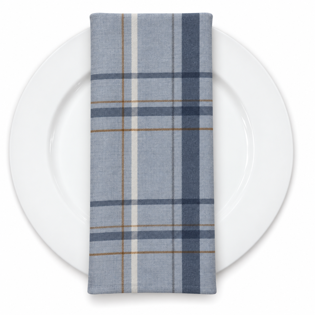 Plaid (Poly Print) in Denim Blue — folded napkin on a white plate