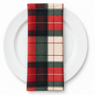 Plaid (Poly Print) in HollyBerry — folded napkin on a white plate