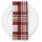 Plaid (Poly Print) in Ruby — folded napkin on a white plate