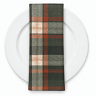 Plaid (Poly Print) in Woodland — folded napkin on a white plate