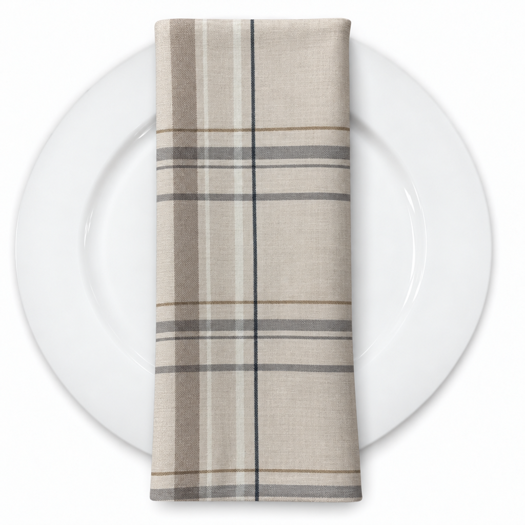 Plaid (Poly Print) in Greige — folded napkin on a white plate