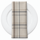 Plaid (Poly Print) in Greige — folded napkin on a white plate